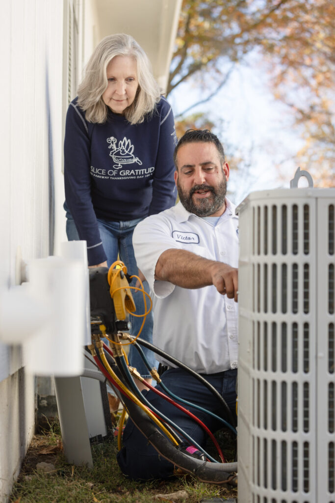 A man focused on fixing an air conditioner