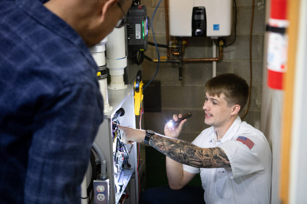 HVAC technician is engaged in repairing a gas furnace