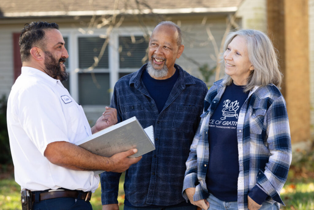 Climate Control staff engage in conversation with clients outside in a casual setting.