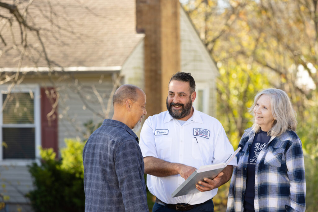 Climate Control staff engage in conversation with clients outside in a casual setting.