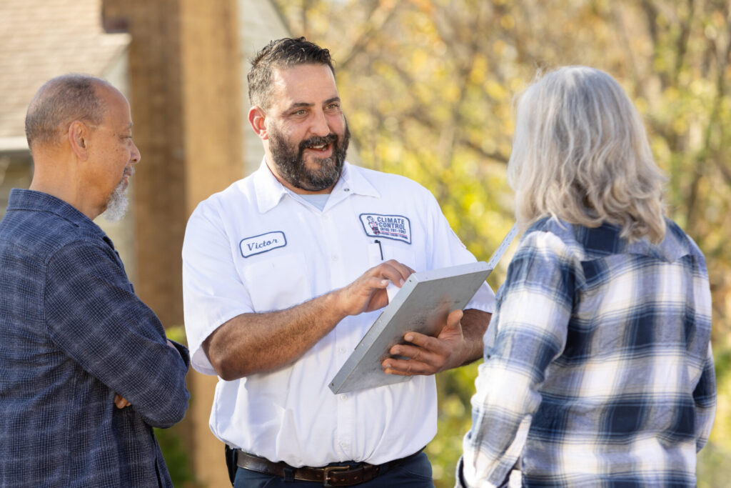 Climate Control staff engage in conversation with clients outside in a casual setting.