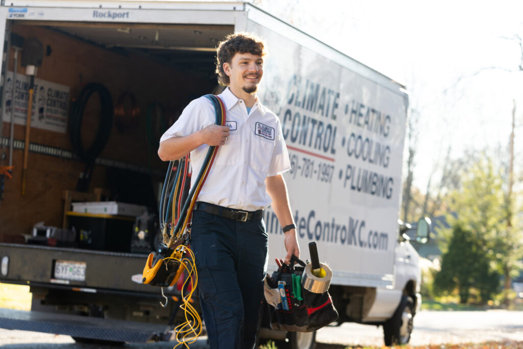 A man stands next to a van, appearing ready for HVAC & Plumbing services