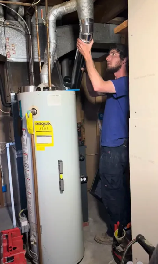 A man is engaged in fixing a water heater